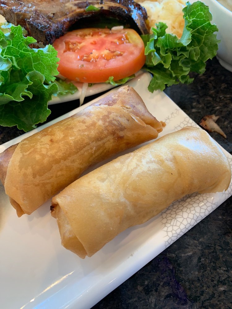 Two fried egg rolls with lettuce and tomato