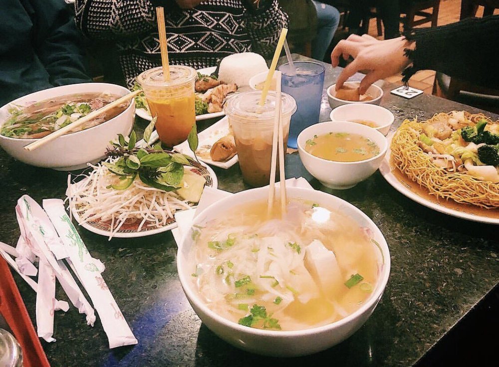 Table of pho, soups, crispy noodles and iced drinks