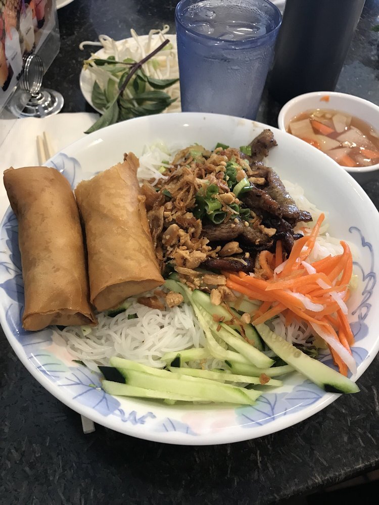 Vermicelli bowl with grilled pork, egg rolls, pickled carrots and cucumber